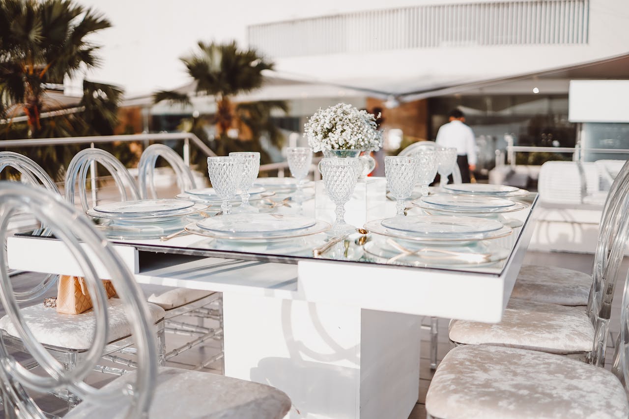 Luxurious outdoor dining table with crystal glasses and velvet chairs, ideal for sophisticated gatherings.